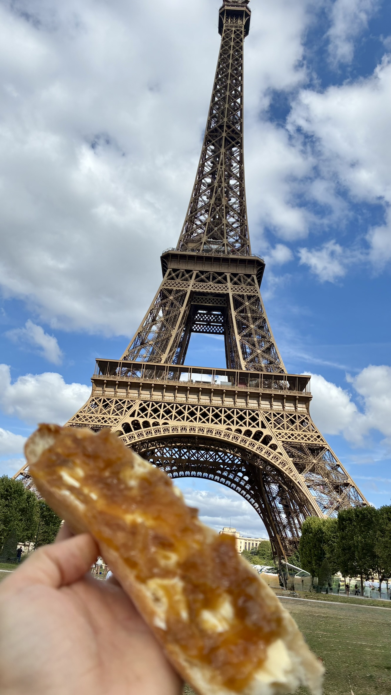 Breakfast of baguette with butter and jam in front of the Eiffel Tower