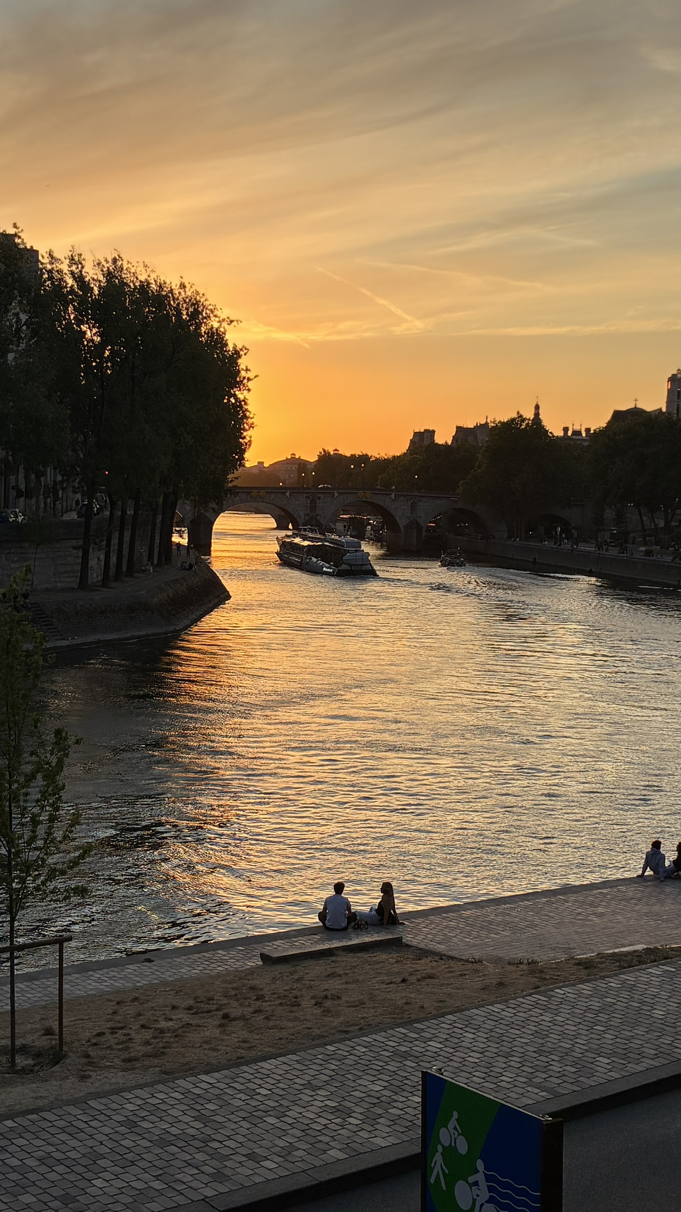 Sunset over the Seine with a bridge and boats